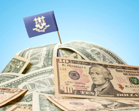 Flag of Connecticut sticking in american banknotes.(series)