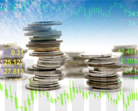 Double exposure of coin stack with financial graph, business and financial concept idea